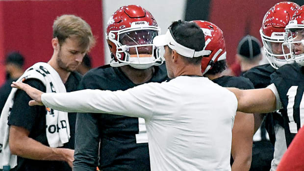 Arkansas offensive coordinator Dan Enos talks to quarterback KJ Jefferson during offseason practices in the Razorback indoor facility.